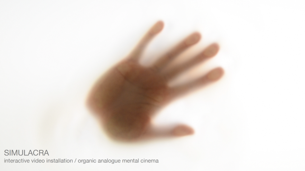 Hand palm from below on a white background, screenshot of the video from the interactive installation SIMULACRA.