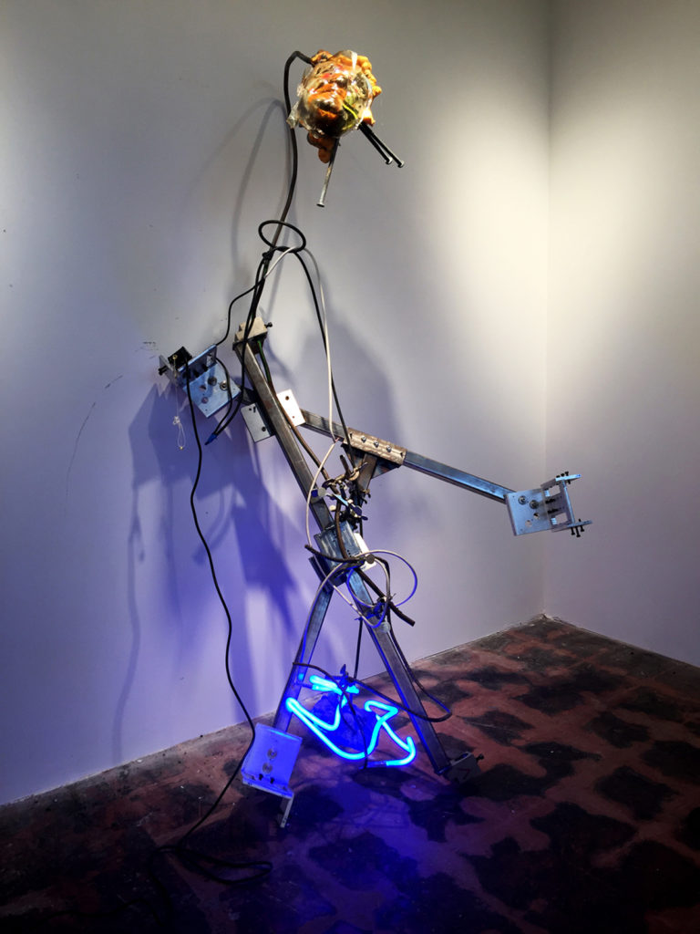 Floor sculpture with rebar, neon, and a security camera
