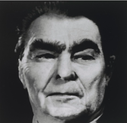 A photographic-looking image in black and white of a portrait of a man whose face is slightly distorted.